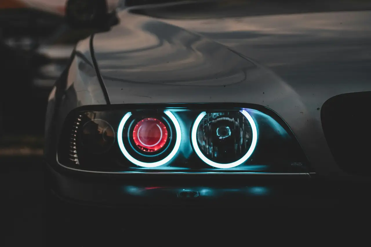 Illuminated performance-car headlight in darkness